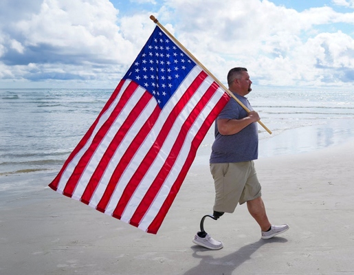 A wonnded vetrain proudly carrying the flag